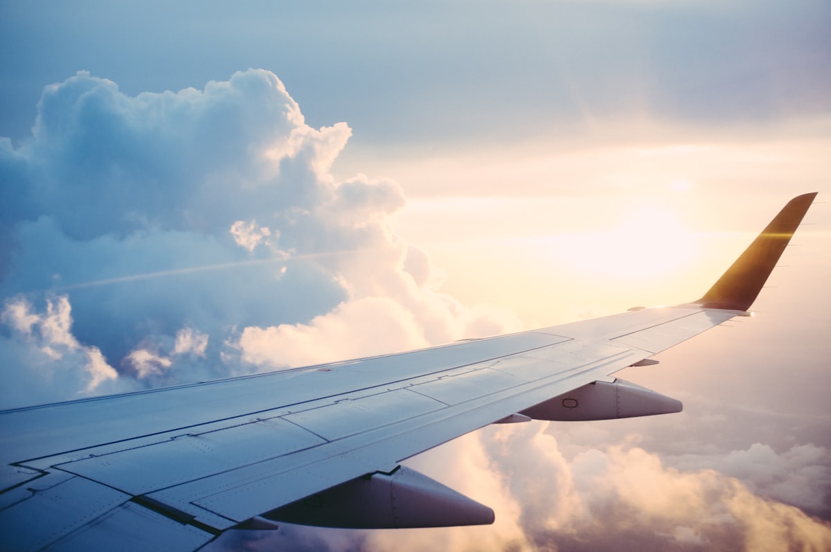 Aircraft wing above clouds